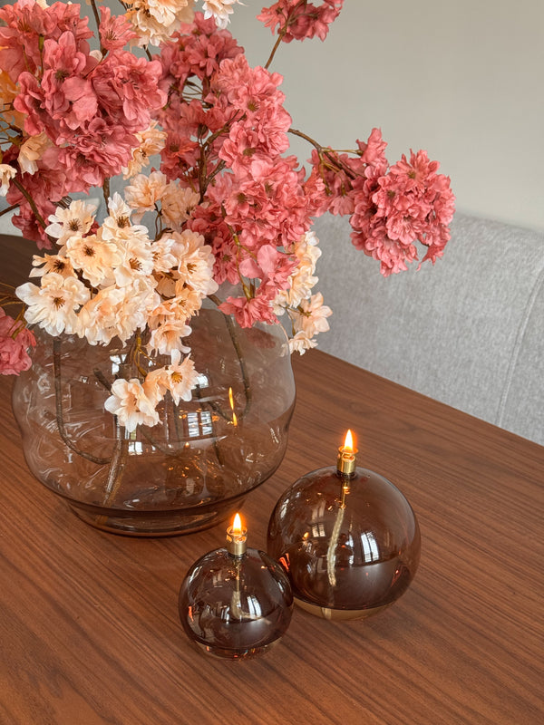 Close-up van luxe realistische zijden bloesemtakken en olielampjes Peri Living