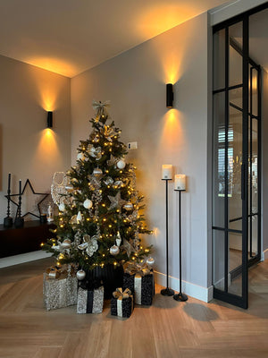 LED_Light_Candle_Rustic_White_Moveable_Flame_PTMD_op een vloerkandelaar bij_een_kerstboom en taatsdeuren